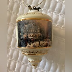 Elegant Thomas Kinkade collectible holiday ornament with winter scene.